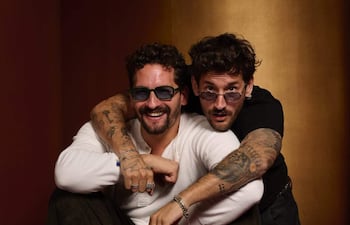 Mau y Ricky sonrientes, vistiendo zapatillas de moda, con colores vibrantes y actitud alegre antes del esperado concierto.