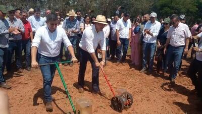 El ministro Carlos Giménez y el presidente de La Cámara de Exportadores de Sésamo Gilberto Ozorio realizan una siembra en una sembradora a mano simbólica en el predio del acto de lanzamiento