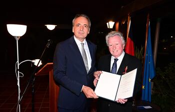 El embajador de Alemania en Paraguay, Gordon Kricke, y el maestro Luis Szarán posan con la condecoración otorgada por la República Federal de Alemania.