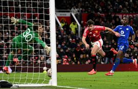 Manchester United's English defender #05 Harry Maguire scores the team's second goal during the English FA Cup fourth round football match between Manchester United and Leicester City at Old Trafford in Manchester, north west England, on February 7, 2025. (Photo by Oli SCARFF / AFP) / RESTRICTED TO EDITORIAL USE. No use with unauthorized audio, video, data, fixture lists, club/league logos or 'live' services. Online in-match use limited to 120 images. An additional 40 images may be used in extra time. No video emulation. Social media in-match use limited to 120 images. An additional 40 images may be used in extra time. No use in betting publications, games or single club/league/player publications. /
