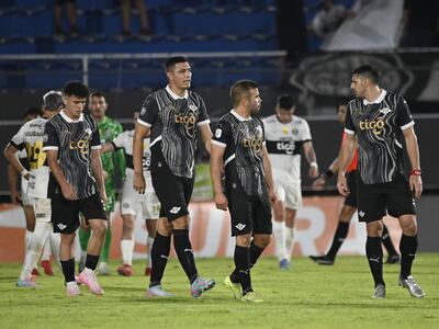 Los jugadores de Libertad dejan el campo de juego después del empate con Olimpia por la vigésima fecha del torneo Apertura 2025 del fútbol paraguayo en el estadio Defensores del Chaco, en Asunción, Paraguay.