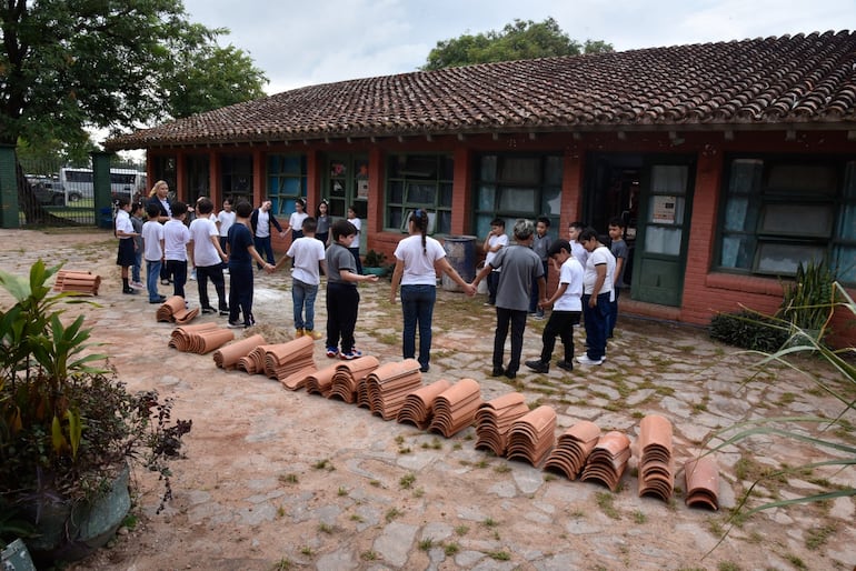 Niños en un juego de integración el primer día de clases, en medio de tejas de una obra en la escuela General Andrés Rodríguez.