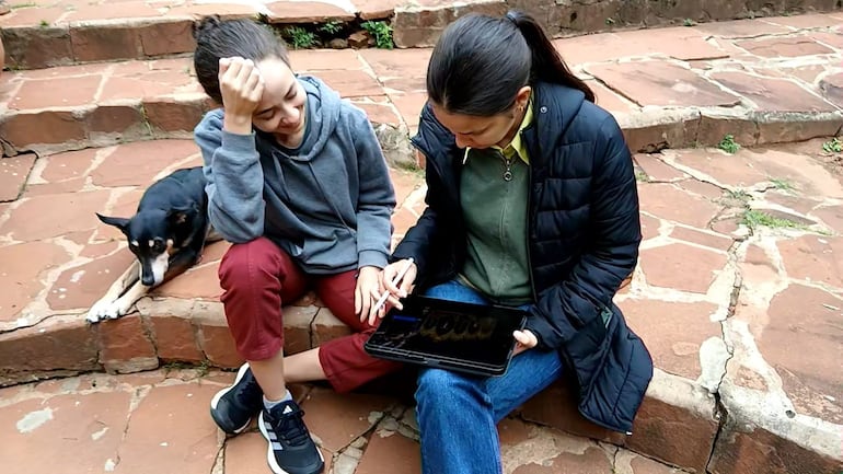 Almudena y Macarena Ruiz realizan los últimos detalles para la colocación del retablo.