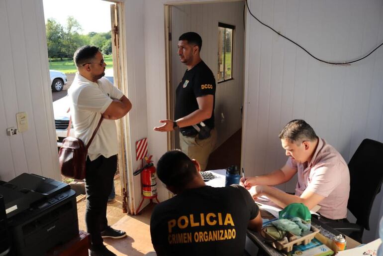 El fiscal Meiji Udagawa y el comisario Pedro Lesme  hablan parados en el allanamiento a la cantera Eureka de Minga Guazú.