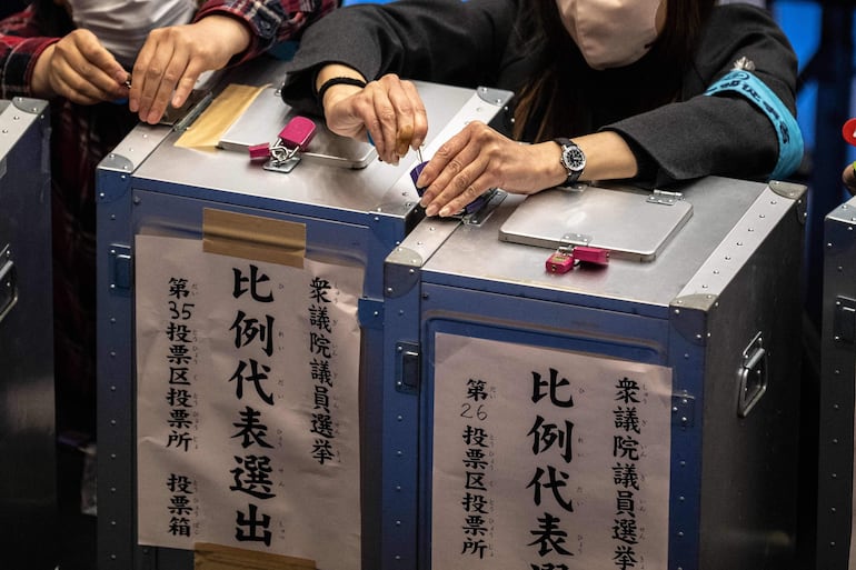 Oficiales electorales de Japón abren las urnas para el conteo de votos.