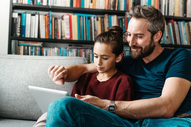 Padre e hija utilizando una tableta electrónica.