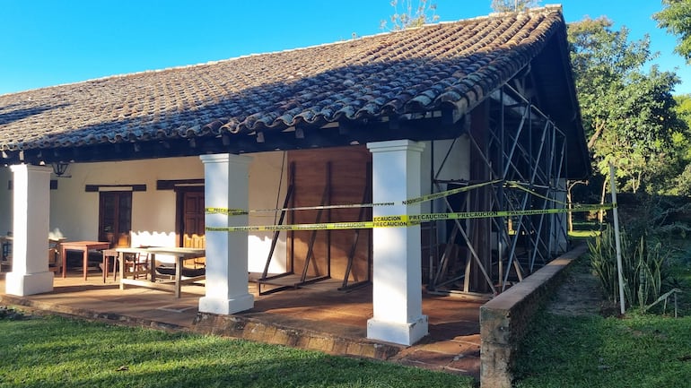 Construcción colonial del Museo Jesuítico con cintas de precaución y mesas de madera en un entorno verde.