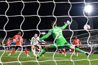 Manchester City's Norwegian striker #09 Erling Haaland (C) shoots past Luton Town's Dutch goalkeeper #23 Tim Krull (front R) and scores his team first goal during the English FA Cup fifth round football match between Luton Town and Manchester City at Kenilworth Road stadium in Luton, central England, on February 27, 2024. (Photo by JUSTIN TALLIS / AFP) / RESTRICTED TO EDITORIAL USE. No use with unauthorized audio, video, data, fixture lists, club/league logos or 'live' services. Online in-match use limited to 120 images. An additional 40 images may be used in extra time. No video emulation. Social media in-match use limited to 120 images. An additional 40 images may be used in extra time. No use in betting publications, games or single club/league/player publications. /