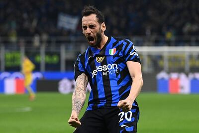 Inter Milan's Turkish midfielder #20 Hakan Calhanoglu celebrates after scoring Inter Milan's second goal during the Italian Serie A football match between Inter Milan and Monza at the San Siro stadium in Milan, on March 8, 2025. (Photo by Isabella BONOTTO / AFP)