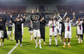 Jugadores de Lyon celebran el triunfo y el liderato en Europa.