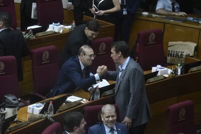 Juan Carlos "Nano" Galaverna saluda a su colega acusado Erico Galeano.