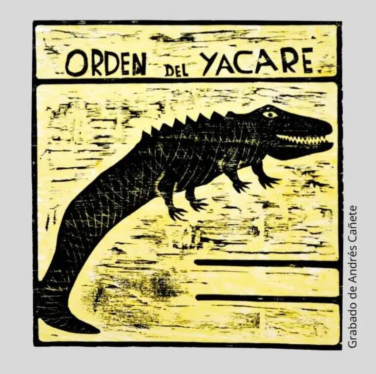 Grabado estilizado de un caimán negro sobre fondo amarillo, con la inscripción 'ORDEN DEL YACARÉ' en la parte superior.