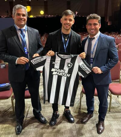 Óscar Romero posa con la camiseta del Botafogo junto al CEO Thairo Arruda (d) y al Football Manager Augusto Oliveira.