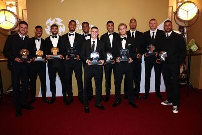 (From L) Arsenal's English midfielder Declan Rice, Aston Villa's English striker Ollie Watkins, Arsenal's Spanish goalkeeper David Raya, Arsenal's French defender William Saliba, Arsenal's Brazilian defender Gabriel Magalhaes, Manchester City's English midfielder Phil Foden, Manchester City's Spanish midfielder Rodri, Arsenal's Norwegian midfielder Martin Odegaard, Liverpool's Dutch defender Virgil van Dijk, Manchester City's Norwegian striker Erling Haaland and Manchester City's English defender Kyle Walker pose in the winner backstage after winning the PFA Divisional Teams of the Year award during the 2023-2024 Professional Footballers' Association (PFA) awards, at the Opera House, in Manchester, northern England, on August 20, 2024. (Photo by Darren Staples / AFP)