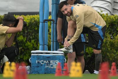Argentina's forward Lionel Messi ties his shoes during training session in Ezeiza, Buenos Aires province, on October 14, 2024, on the eve of the FIFA World Cup 2026 qualifier football match against Bolivia. (Photo by JUAN MABROMATA / AFP)