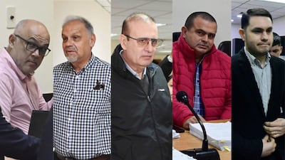 Cinco hombres: uno con gafas y camisa rosa, otro en chaqueta negra, uno serio en chaqueta roja, otro en chaqueta oscura.