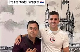 Santiago Peña en camiseta blanca y pantalones cortos, sonriente, junto a otro hombre con mochila en un entorno deportivo.