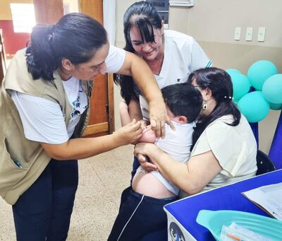 Una enfermera aplica una vacuna contra el sarampión a un niño.