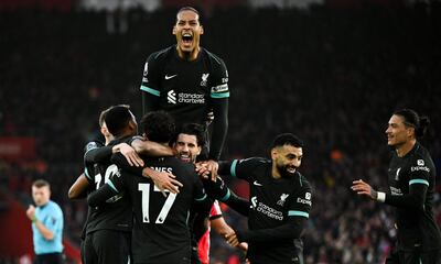 TOPSHOT - Liverpool's Hungarian midfielder #08 Dominik Szoboszlai (C) celebrates with teammates after scoring his team first goal during the English Premier League football match between Southampton and Liverpool at St Mary's Stadium in Southampton, southern England on November 24, 2024. (Photo by JUSTIN TALLIS / AFP) / RESTRICTED TO EDITORIAL USE. No use with unauthorized audio, video, data, fixture lists, club/league logos or 'live' services. Online in-match use limited to 120 images. An additional 40 images may be used in extra time. No video emulation. Social media in-match use limited to 120 images. An additional 40 images may be used in extra time. No use in betting publications, games or single club/league/player publications. /