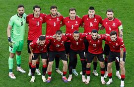 Portugal's players including (From L) Georgia's goalkeeper #25 Giorgi Mamardashvili, Georgia's defender #15 Giorgi Gvelesiani, Georgia's midfielder #17 Otar Kiteishvili, Georgia's defender #03 Lasha Dvali, Georgia's midfielder #10 Giorgi Chakvetadze, Georgia's defender #02 Otar Kakabadze, Georgia's midfielder #06 Giorgi Kochorashvili, Georgia's defender #14 Luka Lochoshvili, Georgia's forward #22 Georges Mikautadze, Georgia's defender #04 Guram Kashia and Georgia's forward #07 Khvicha Kvaratskhelia pose prior to the UEFA Euro 2024 Group F football match between Georgia and Portugal at the Arena AufSchalke in Gelsenkirchen on June 26, 2024. (Photo by KENZO TRIBOUILLARD / AFP)