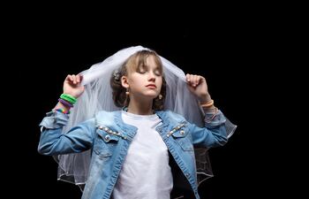 Una adolescente se prueba un velo de novia.