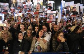 Tel Aviv (Israel), 13/01/2024.- Supporters and families react as others hold pictures of hostages held by Hamas in Gaza as they take part in a '100 Days of Hell' rally calling for their immediate release and marking the upcoming 100th day of their captivity, outside the Kirya military base in Tel Aviv, Israel, 13 January 2024. According to the Israeli government, 136 Israelis are still being held hostage by Hamas in the Gaza Strip. According to organizers, some 120,000 people attended the rally to mark the upcoming one-hundredth day, on 14 January 2024, since the 07 October Hamas attack on Israel. More than 23,600 Palestinians and at least 1,300 Israelis have been killed, according to the Palestinian Health Ministry and the Israel Defense Forces (IDF), since Hamas militants launched an attack against Israel from the Gaza Strip on 07 October, and the Israeli operations in Gaza and the West Bank which followed it. EFE/EPA/ABIR SULTAN