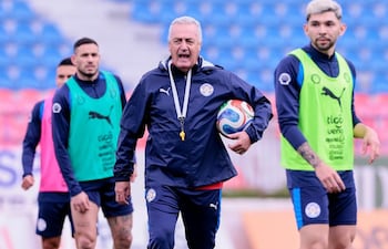 El entrenador de la selección paraguaya de fútbol, Gustavo Alfaro dirigiendo el entrenamiento albirrojo en medio de Antonio Sanabria y Julio Enciso.