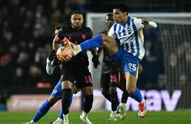 Brighton's Paraguayan midfielder #25 Diego Gomez (R) vies with Chelsea's French striker #18 Christopher Nkunku during the English FA Cup fourth round football match between Brighton & Hove Albion and Chelsea at the Amex stadium, in Brighton, southern England on February 8, 2025. (Photo by Ben STANSALL / AFP) / RESTRICTED TO EDITORIAL USE. No use with unauthorized audio, video, data, fixture lists, club/league logos or 'live' services. Online in-match use limited to 120 images. An additional 40 images may be used in extra time. No video emulation. Social media in-match use limited to 120 images. An additional 40 images may be used in extra time. No use in betting publications, games or single club/league/player publications. /