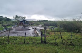 Paisaje rural en Villa Florida sin personas, con estructuras de madera y vegetación, bajo un cielo nublado.