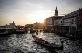 Una góndola navega por el Gran Canal, frente al Palazzo Ducale de Venecia.