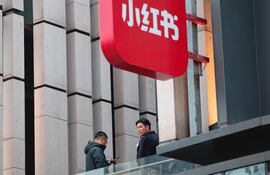 Los empleados están de pie en el balcón del edificio de la sede de la empresa Xiaohongshu (Pequeño Libro Rojo), también conocida como 'RedNote', en Shanghái, China.