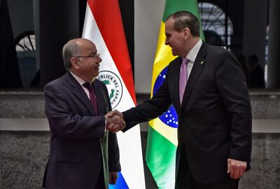 Brazil's Foreign Minister Mauro Vieira (L) and his Paraguayan counterpart Julio Cesar Arriola shake hands during a meeting in Asuncion on March 9, 2023. (Photo by Norberto DUARTE / AFP)