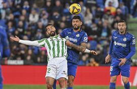 GETAFE, 23/02/2025. El centrocampista del Betis, Isco (i), disputa el balón ante el defensa paraguayo del Getafe, Omar Alderete, durante el encuentro correspondiente a la jornada 25 de Laliga EA Sports que disputan hoy domingo Getafe y Betis en el Coliseum de la localidad madrileña. EFE / Fernando Villar.