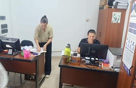 Momento en que la abogada Sinthia Ruiz (izquierda) presenta la carpeta de denuncia en el despacho del fiscal José Godoy, en Santa Rosa del Aguaray.