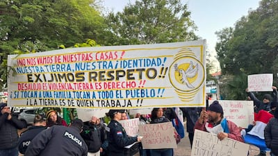 Grupo de manifestantes en Asunción sosteniendo pancartas con mensajes de protesta sobre desalojo y derechos sociales.