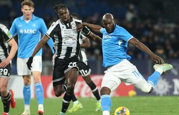 Napoli's Belgian forward #11 Romelu Lukaku (R) fights for the ball with Udinese's French defender #28 Oumar Solet (C) during the Italian Serie A football match between Napoli and Udinese at the Diego Armando Maradona Stadium in Naples on February 9, 2025. (Photo by CARLO HERMANN / AFP)
