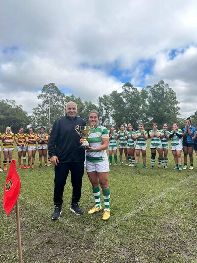 Fredy Fariña directivo de la URP entrega el trofeo de campeón a Verónica Paredes, la capitana de Cristo Rey.