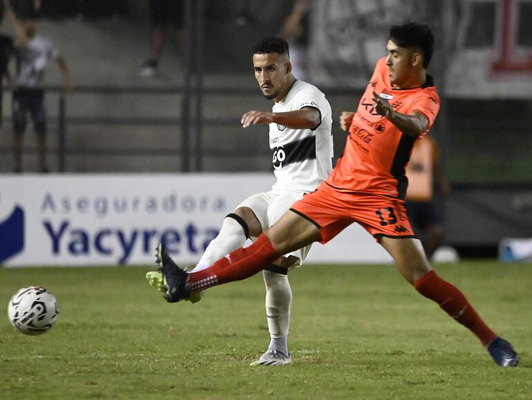 Fernando Cardozo (i), jugador de Olimpia, y Leandro Meza, futbolista de Nacional, pelean por el balón en el partido por la décimo cuarta jornada del torneo Apertura 2024 del fútbol paraguayo en el estadio Arsenio Erico, en Asunción.