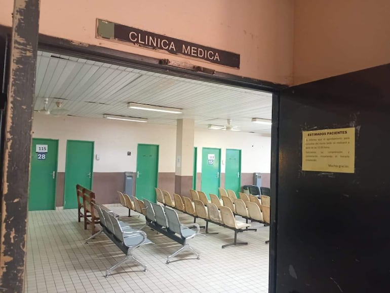 Interior desocupado de la Clínica Médica en Itauguá, con cartel informativo de retraso en atención.