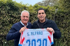 El entrenador argentino, Gustavo Alfaro y el presidente de la APF Robert Harrison, sosteniendo la camiseta albirroja con el dorsal 2030, sellando el acuerdo entre partes.