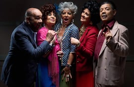 Calolo Rodríguez gesticula con entusiasmo junto a Chela Villagra, Karina Otazú, Regina Bachero y Dani González, todos en vestimenta colorida.