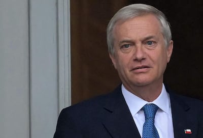 Chile's President Jose Antonio Kast gestures on the balcony of the Casa Rosada government palace after a meeting with Argentinas President Javier Milei (out of frame), in Buenos Aires on April 6, 2026. Kast's first trip abroad since taking office in March continues the tradition of Chilean presidents making Argentina their first official state trip. Politically aligned, Kast and Argentina's libertarian President Javier Milei are close allies of US President Donald Trump and are part of the growing rightward push in the region. (Photo by Juan Mabromata / AFP)