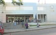Entrada del Centro IPS con personas esperando y conversando en un ambiente moderno y activo.