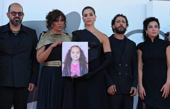 Actor israelí Amer Hlehel, director turco Kaouther Ben Hania, actriz Saja Kilani, actor Motaz Malhees, actriz Clara Khoury posan con un retrato de Hind Rajab, en la alfombra roja del festival de Venecia.