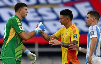 Argentina's goalkeeper Emiliano Martinez (L) greets Colombia's midfielder James Rodriguez at the end of the 2026 FIFA World Cup South American qualifiers football match between Colombia and Argentina, at the Metropolitano Roberto Meléndez stadium in Barranquilla, Colombia, on September 10, 2024. (Photo by RAUL ARBOLEDA / AFP)
