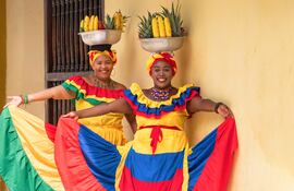 Vendedoras ambulantes sonrientes, Palenqueras típicas de Cartagena, Colombia.
