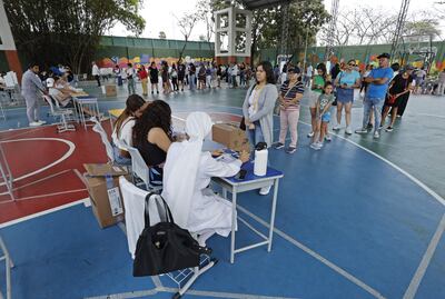 Ciudadanos acuden a votar durante la jornada de elecciones generales, hoy, en Guayaquil (Ecuador).