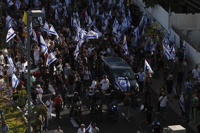 Israelis attend the funeral of Hanan Yablonka, one of the Israeli hostages held in the Gaza Strip since the October 7, 2023 attack by Palestinian Hamas militants, in Tel Aviv on May 26, 2024, as they also chant slogans demanding the release of the rest of the hostages. The Israeli army said on May 24, that troops had retrieved the bodies of three hostages in an overnight operation in Jabalia in the northern Gaza Strip. (Photo by Menahem KAHANA / AFP)