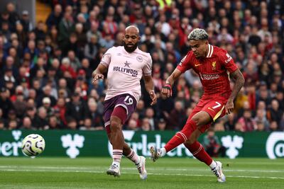Liverpool's Colombian midfielder #07 Luis Diaz scores the team's first goal during the English Premier League football match between Liverpool and Brentford at Anfield in Liverpool, north west England on August 25, 2024. (Photo by Darren Staples / AFP) / RESTRICTED TO EDITORIAL USE. No use with unauthorized audio, video, data, fixture lists, club/league logos or 'live' services. Online in-match use limited to 120 images. An additional 40 images may be used in extra time. No video emulation. Social media in-match use limited to 120 images. An additional 40 images may be used in extra time. No use in betting publications, games or single club/league/player publications. /