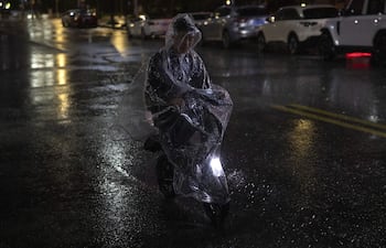 Un viajero va en un scooter eléctrico bajo la lluvia antes de la llegada del tifón Bavi, en Wenzhou, provincia de Zhejiang, este de China, 11 de julio de 2026. El Centro Meteorológico Nacional de China (NMC) ha emitido varias alertas de tifón antes de la llegada esperada del tifón Bavi a lo largo de la costa este de China entre la noche del 11 de julio y la madrugada del 12 de julio. Las zonas costeras de las provincias de Zhejiang y Fujian podrían experimentar lluvias torrenciales de 250 a 400 milímetros.